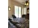 Comfortable bedroom with ceiling fan, slider access to the lanai, and plenty of natural light at 3539 Maple Ridge Loop, Kissimmee, FL 34741