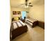Bedroom featuring twin beds, ceiling fan, neutral walls, and carpet flooring at 3539 Maple Ridge Loop, Kissimmee, FL 34741