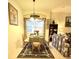 Cozy dining area with a round table, four chairs, and bright window at 3539 Maple Ridge Loop, Kissimmee, FL 34741