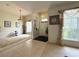 Spacious foyer with neutral carpet, tile flooring, and decorative lighting at 3539 Maple Ridge Loop, Kissimmee, FL 34741