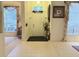 Bright foyer featuring tile flooring, a front door, and decorative window treatments at 3539 Maple Ridge Loop, Kissimmee, FL 34741