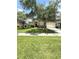 Lovely single-story home featuring a manicured lawn, mature trees, and a welcoming facade at 3539 Maple Ridge Loop, Kissimmee, FL 34741