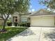 Beautiful one-story house with a wide driveway, mature trees, and manicured lawn at 3539 Maple Ridge Loop, Kissimmee, FL 34741