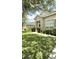 Inviting single-Gathering home boasting a red front door, lush lawn, and well-kept shrubbery at 3539 Maple Ridge Loop, Kissimmee, FL 34741