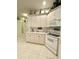 Bright kitchen featuring white cabinets, appliances, and tiled backsplash at 3539 Maple Ridge Loop, Kissimmee, FL 34741