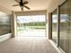 Enjoy serene water views from this screened lanai with tile flooring and ceiling fan at 3539 Maple Ridge Loop, Kissimmee, FL 34741