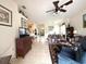 Spacious living room with tile flooring, a ceiling fan, and views to the kitchen at 3539 Maple Ridge Loop, Kissimmee, FL 34741