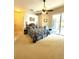 Spacious main bedroom with a ceiling fan, sliding glass door access, and comfortable sitting area at 3539 Maple Ridge Loop, Kissimmee, FL 34741
