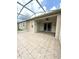 A spacious screened patio features tiled flooring and a ceiling fan for comfortable outdoor living at 3539 Maple Ridge Loop, Kissimmee, FL 34741
