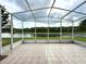 A tiled, screened-in lanai offers peaceful lake views and seamless indoor-outdoor living at 3539 Maple Ridge Loop, Kissimmee, FL 34741