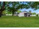 Well-maintained backyard featuring lush green grass and a covered patio for outdoor relaxation at 4 Kasey Dr, Orlando, FL 32807