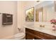 Cozy bathroom featuring a stylish vanity, neutral tones, and a framed floral painting adding a touch of elegance at 4 Kasey Dr, Orlando, FL 32807