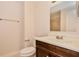 Bathroom with a stylish vanity, toilet, towel rack, and tiled shower in the background at 4 Kasey Dr, Orlando, FL 32807