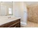 Updated bathroom featuring a new vanity, toilet, and tiled walk-in shower at 4 Kasey Dr, Orlando, FL 32807