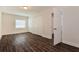 Bedroom with dark wood floors, double closets, and a window for ample natural light at 4 Kasey Dr, Orlando, FL 32807