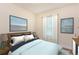 Cozy bedroom with a comfortable bed, neutral walls, soft window lighting, and attractive wall art at 4 Kasey Dr, Orlando, FL 32807