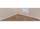 Bright bedroom featuring neutral walls and carpeted floor, complemented by a window for natural light at 4 Kasey Dr, Orlando, FL 32807