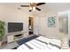 Bedroom featuring a ceiling fan and open bathroom view at 4 Kasey Dr, Orlando, FL 32807