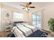 Inviting bedroom featuring a ceiling fan and a sliding glass door to the screened patio at 4 Kasey Dr, Orlando, FL 32807