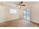 Cozy bedroom with new carpet, ceiling fan, and sliding glass doors to the outside patio at 4 Kasey Dr, Orlando, FL 32807