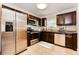 Modern kitchen with stainless steel appliances, granite countertops, and dark wood cabinets at 4 Kasey Dr, Orlando, FL 32807