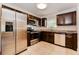 Modern kitchen with stainless steel appliances, dark cabinetry, and granite countertops at 4 Kasey Dr, Orlando, FL 32807