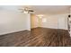 Open-concept living room featuring stylish dark wood flooring, ceiling fan and modern lighting at 4 Kasey Dr, Orlando, FL 32807