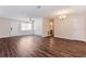 Bright living room with dark wood flooring, ample natural light, and updated fixtures at 4 Kasey Dr, Orlando, FL 32807