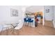 Inviting dining area with wood-look tile, stylish lighting, and bar seating overlooking the kitchen at 4011 Venetian Bay Dr # 103, Kissimmee, FL 34741