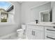 Bathroom with a vanity, modern faucet, white marble floors, and a window for natural light at 42157 Tamarac St, Eustis, FL 32736