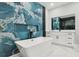 Bathroom featuring a soaking tub and a blue accent wall creating a relaxing and spa-like atmosphere at 42157 Tamarac St, Eustis, FL 32736