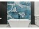 Bathroom featuring a soaking tub and a blue accent wall creating a spa-like atmosphere at 42157 Tamarac St, Eustis, FL 32736