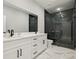 Modern bathroom featuring double vanity, stone shower, and marble floors at 42157 Tamarac St, Eustis, FL 32736