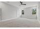 Spacious bedroom featuring neutral walls, carpet flooring, and a modern ceiling fan at 42157 Tamarac St, Eustis, FL 32736