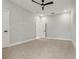 A carpeted bedroom with neutral walls, ceiling fan and bright natural light coming from the window at 42157 Tamarac St, Eustis, FL 32736