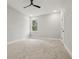 This is a bedroom featuring carpeted floor, neutral walls and a window, with a ceiling fan at 42157 Tamarac St, Eustis, FL 32736