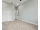 This is a bright bedroom with a closet and neutral decor with a carpeted floor at 42157 Tamarac St, Eustis, FL 32736