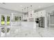 Contemporary kitchen with stainless steel appliances, white cabinetry, and island, with marble floors at 42157 Tamarac St, Eustis, FL 32736