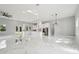 Spacious kitchen with stainless steel appliances, white cabinets, marble floors, and modern lighting at 42157 Tamarac St, Eustis, FL 32736