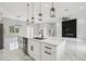 Modern kitchen with a large center island, sleek white cabinetry, and an open view of the spacious living area at 42157 Tamarac St, Eustis, FL 32736