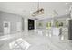 A modern living space features marble floors, an entertainment center, and a well-appointed kitchen at 42157 Tamarac St, Eustis, FL 32736