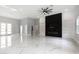 Bright and airy living room featuring marble floors, a modern fireplace, and double doors leading to the outdoors at 42157 Tamarac St, Eustis, FL 32736