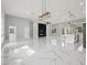 Bright living area featuring marble floors, a modern entertainment center, and an open floor plan at 42157 Tamarac St, Eustis, FL 32736