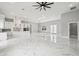 Spacious living room with marble flooring, modern lighting fixtures, and an open layout to kitchen at 42157 Tamarac St, Eustis, FL 32736