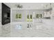 Open-concept living space featuring marble floors, a modern fireplace, and a seamless transition to the kitchen at 42157 Tamarac St, Eustis, FL 32736