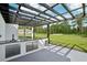 Modern outdoor kitchen featuring sleek cabinets, a sink, and a pergola with a beautiful view at 42157 Tamarac St, Eustis, FL 32736