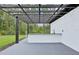 Outdoor kitchen under pergola with a bar top and a nice view of trees and greenery at 42157 Tamarac St, Eustis, FL 32736