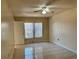 Bedroom with ceiling fan, tile flooring, neutral paint, and window with white blinds at 436 Hunter Cir, Kissimmee, FL 34758