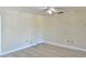 Bright bedroom with tile flooring, ceiling fan, neutral paint, and baseboard trim at 436 Hunter Cir, Kissimmee, FL 34758