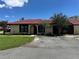 Single-story home features a red tiled roof, light yellow walls, dark trim, and simple landscaping at 436 Hunter Cir, Kissimmee, FL 34758